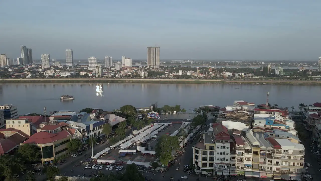 Aerial rotates down Tonle Sap River in city of Phnom Penh Cambodia