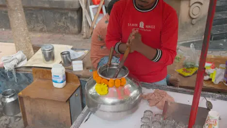 Close Up Of Man On Stall Churning Curd To Make Buttermilk Or Chaas In Mumbai India