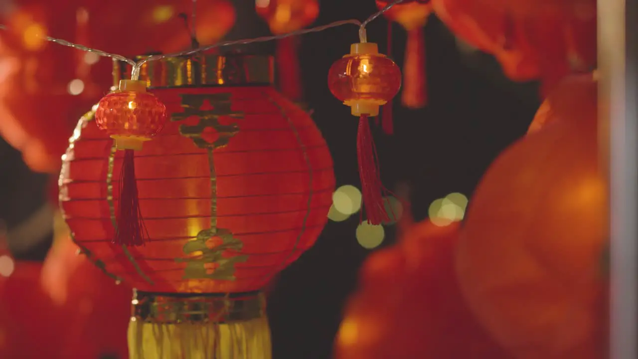 Close Up Of Colourful Chinese Lanterns And Lights Celebrating New Year Hung Against Black Background 3