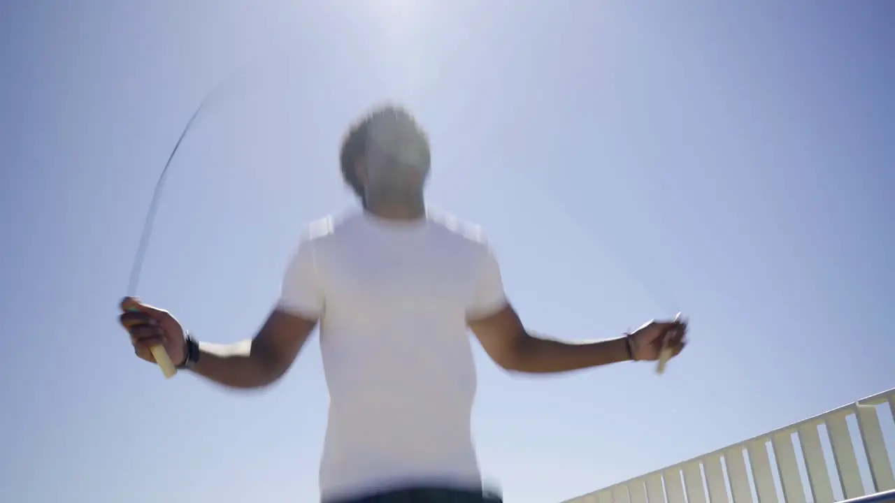 Bottom view of African American man skipping rope outdoor