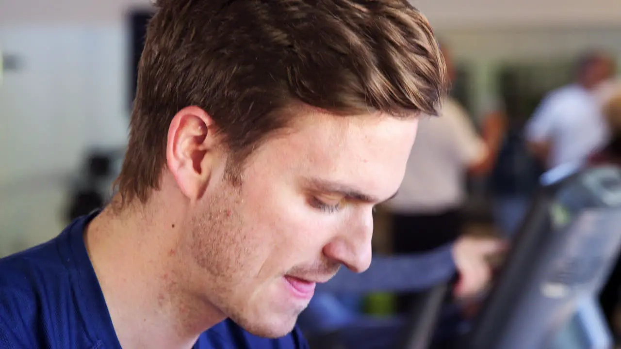 Close Up Of Man Exercising On Cycling Machine In Gym