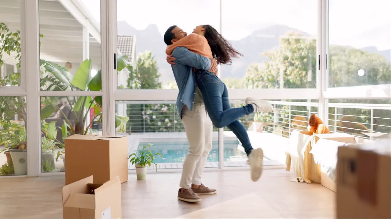 Happy couple hug and real estate in new home