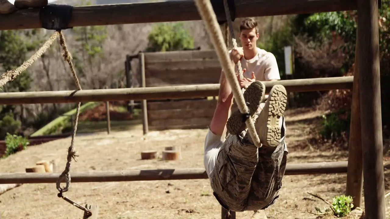 Military soldier crossing the rope during obstacle course 4k