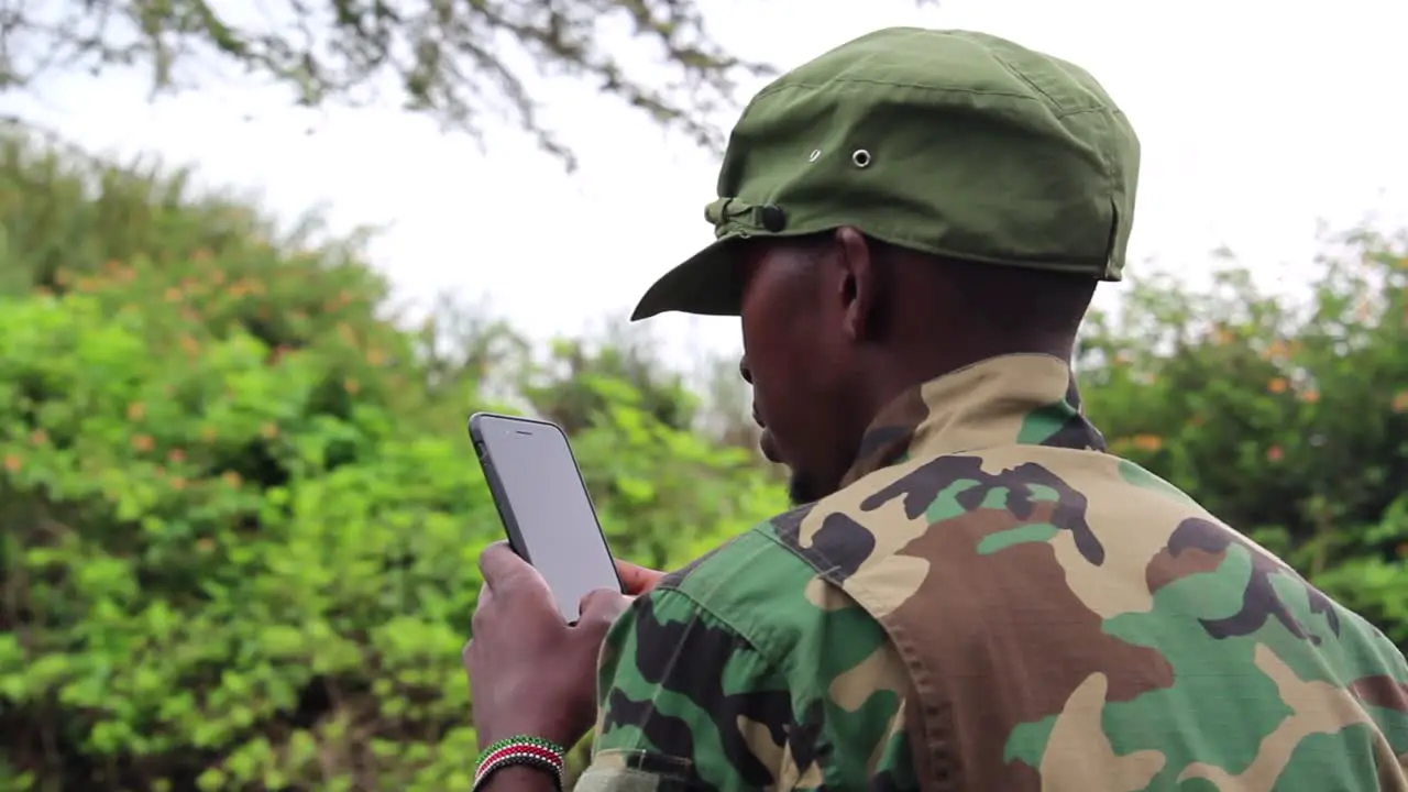 African militant guerilla using his cellphone