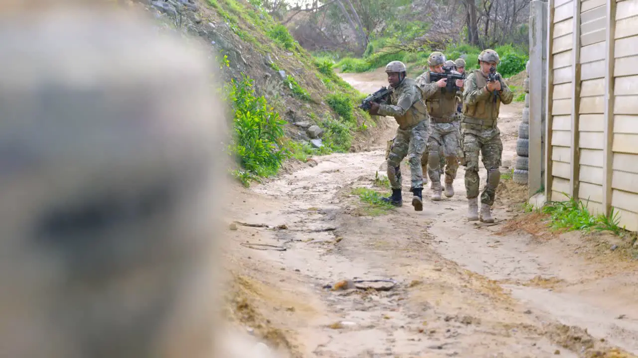 Front view of mixed-race military soldiers rifle training in fields during military training 4k 