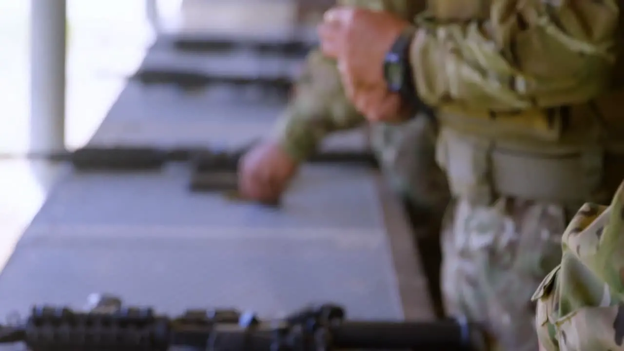 Side view of caucasian military soldiers loading weapon during training 4k