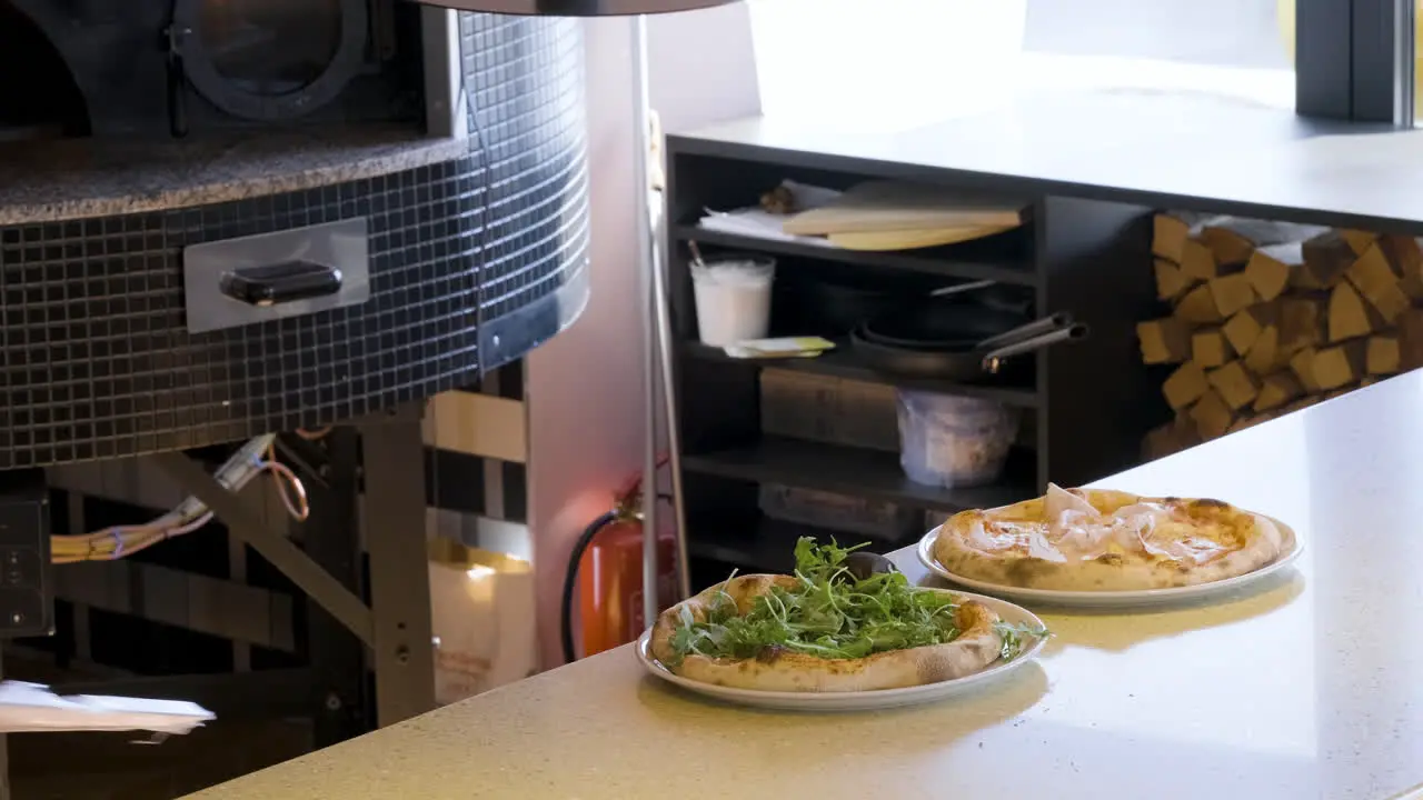 Chef Añadiendo Rúcula A La Pizza En El Restaurante