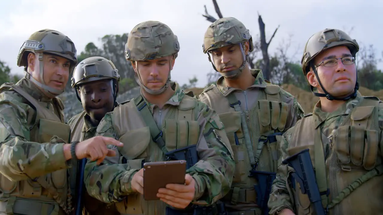 Front view of military soldiers using digital tablet during training 4k