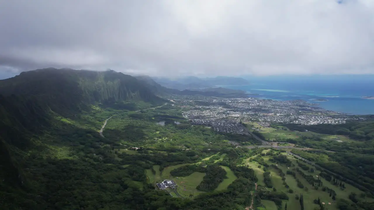 Nu‘uanu Pali overlooking cliff with city scape and blue ocean in the distance