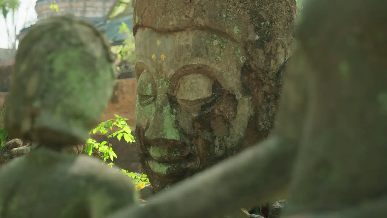 4K Cinematic slow motion footage of ruins of Buddhist statues at Wat Umong Temple in Chiang Mai Northern Thailand on a sunny day