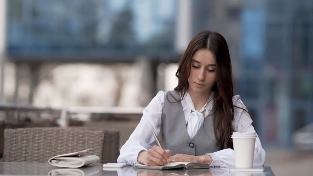 Cute Stylish Woman Sitting On Summer Terrace Receives Joyful Message On Phone