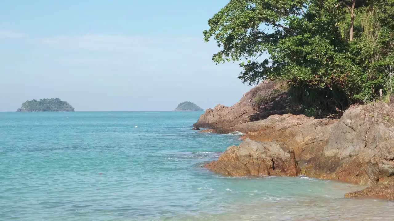 granite rock tropical headland with ocean and Islands in distance