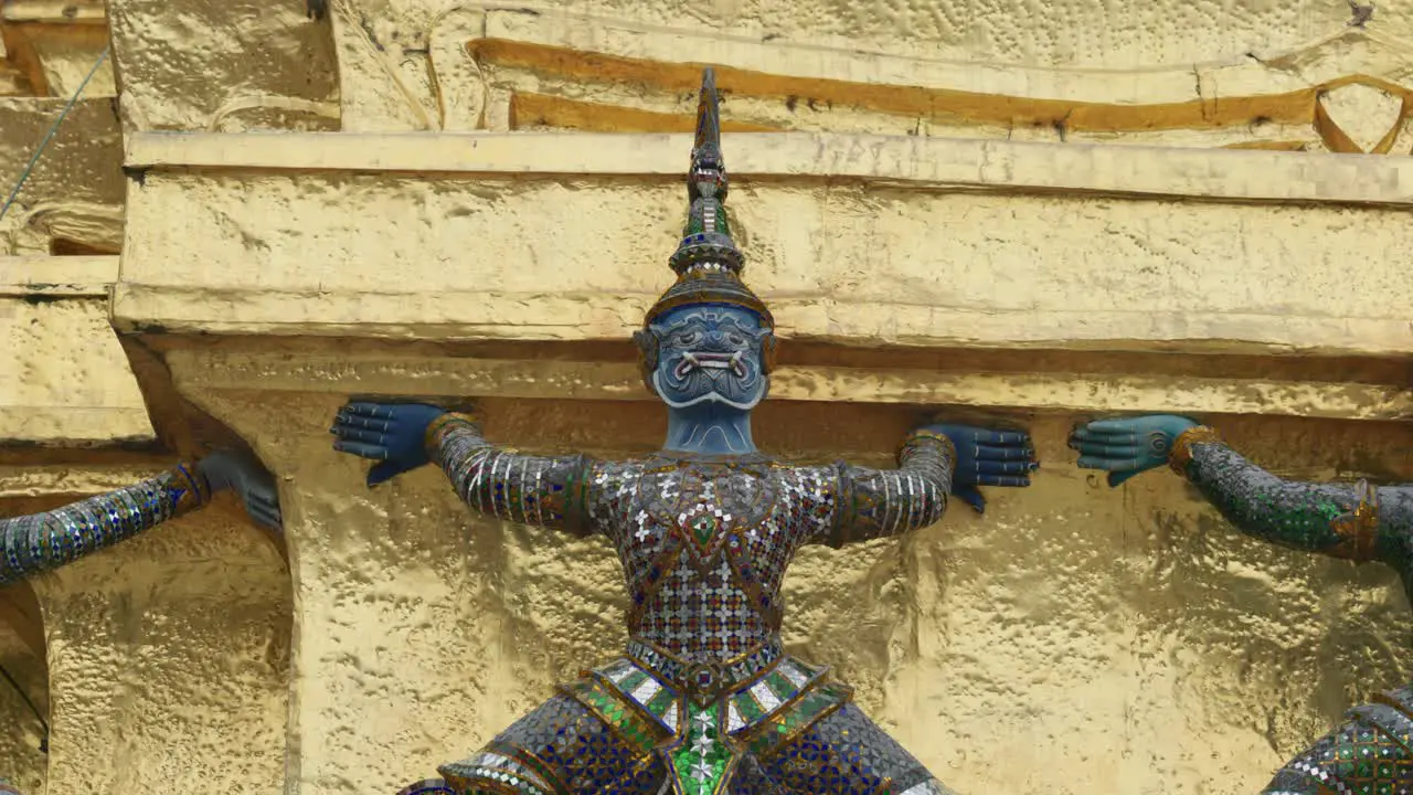 4K Cinematic religious travelling footage of Yak statues at the Temple of the Emerald Buddha Wat Phra Kaew in Bangkok Thailand on a sunny day