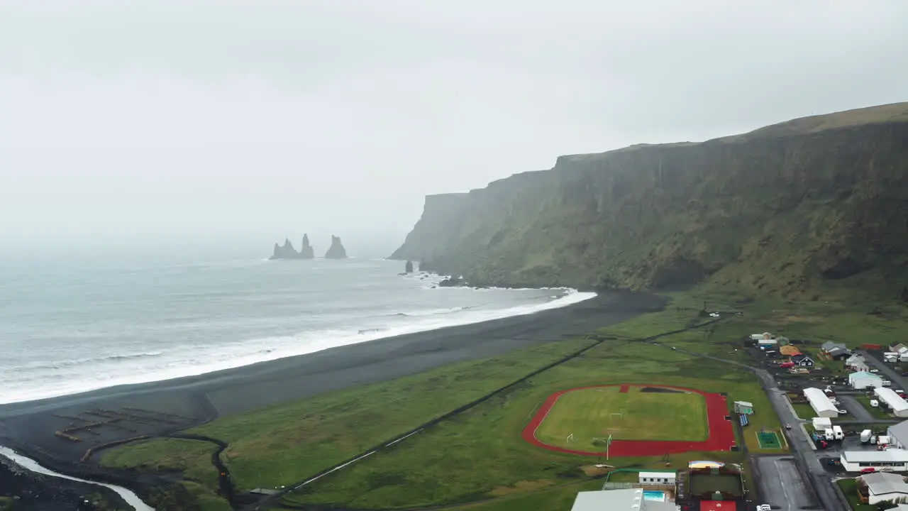 Aerial Drone view over Black Sand Beach in Vík í Mýrdal Iceland Dramatic misty view over Icelandic Coastline