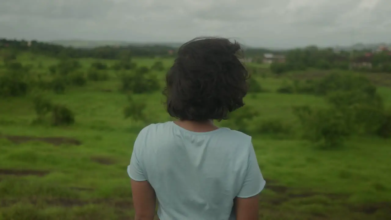 Indian young girl stands at the edge of the lush Goa India forest her gaze fixed upon the enchanting greenery ahead