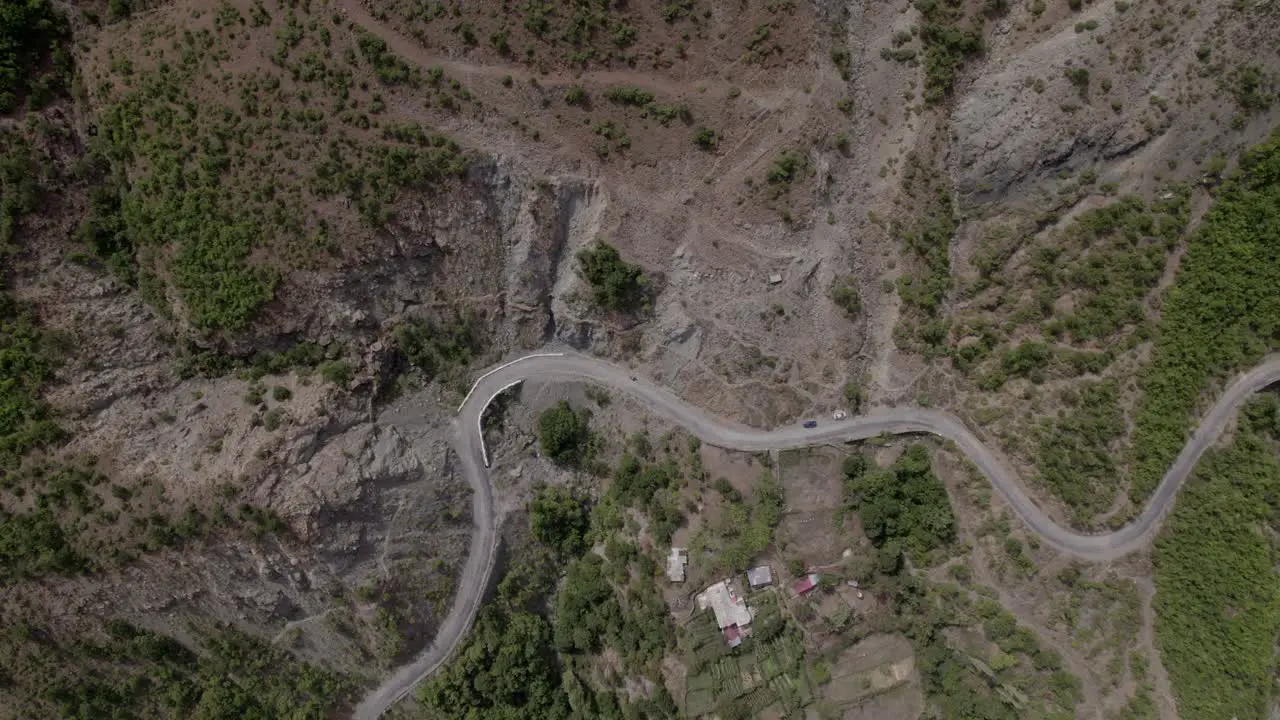 Video with drone of previous aerial shot of a crane ascending on the Sh25 in albania with the Drin River in the plane