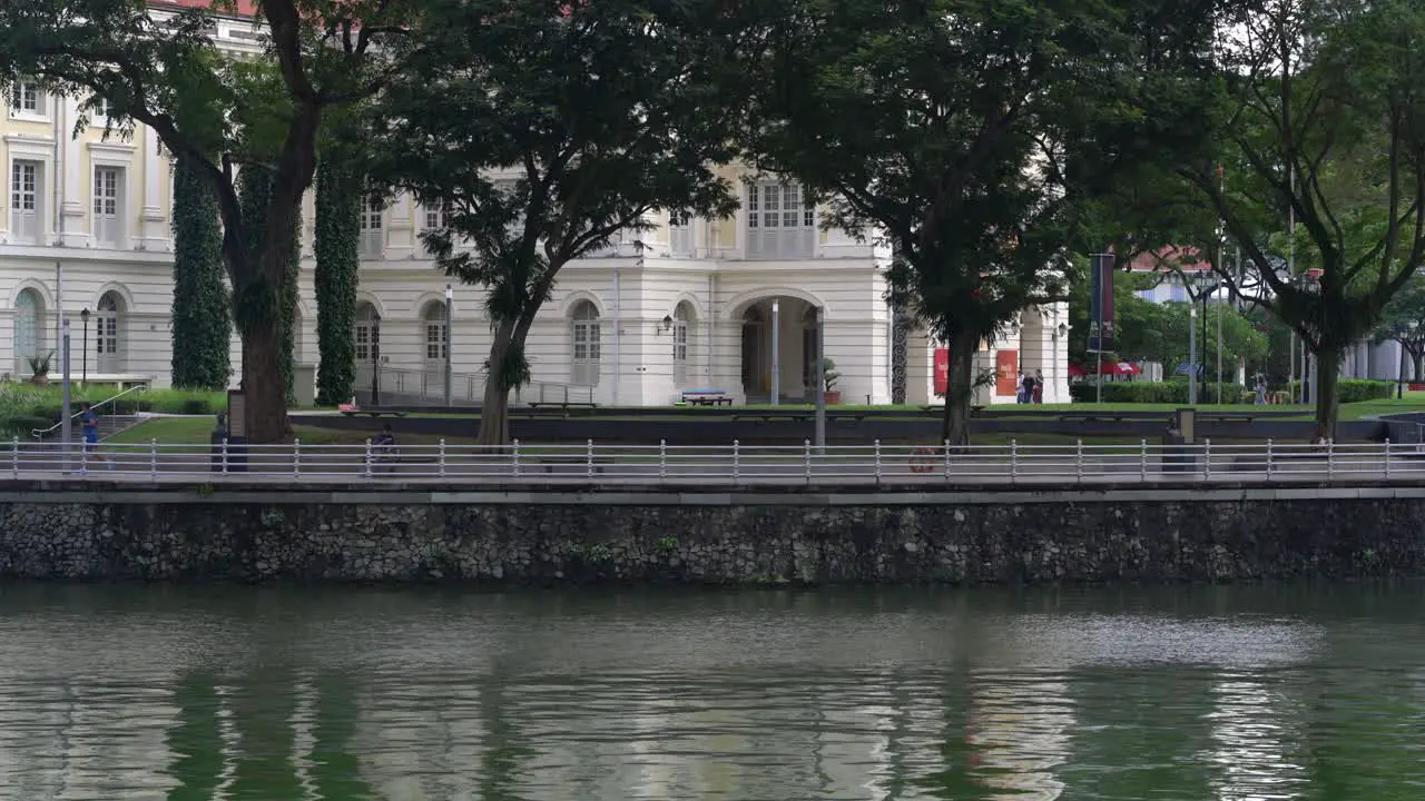 People jogging and cycling riverside Singapore river