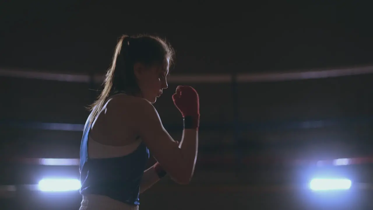 Athletic woman doing fitness exercises to box and practice self-defensive techniques steadicam shot