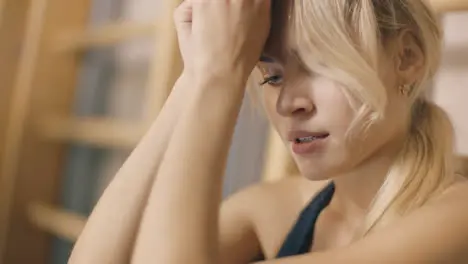 Portrait of upset girl sitting in fitness gym