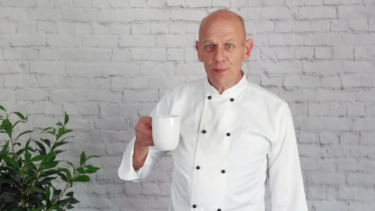 A chef taste tests a drink in his office