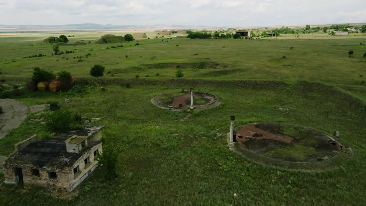 Desolate building and artillery foxholes in Shiraki military airfield