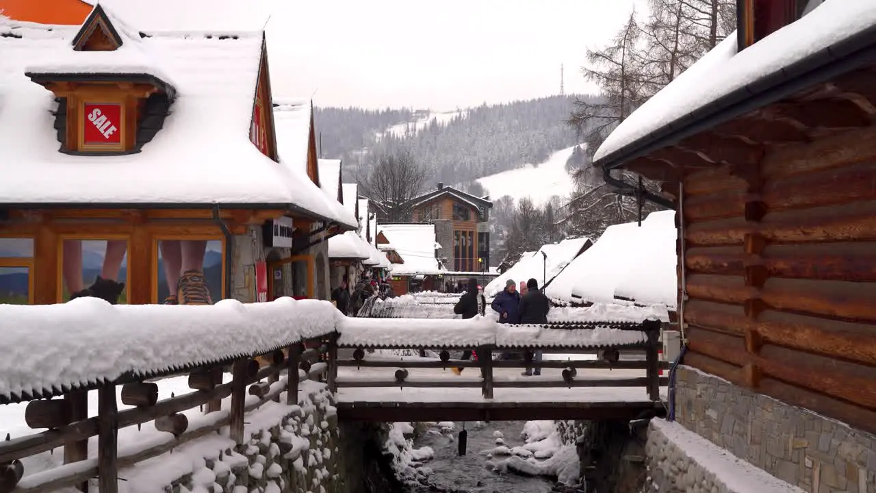 People standing on small bridge taking pictures in Zakopane Poland in winter