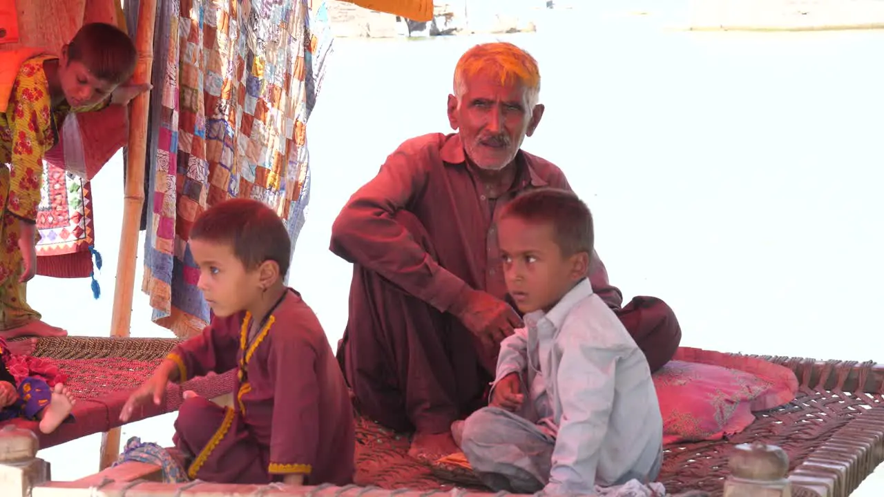 Family Sitting In Make Shift Tent At Flood Relief Camp In Maher Sindh