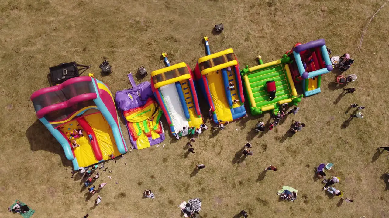 Top down aerial view of kids playing in inflatable playground