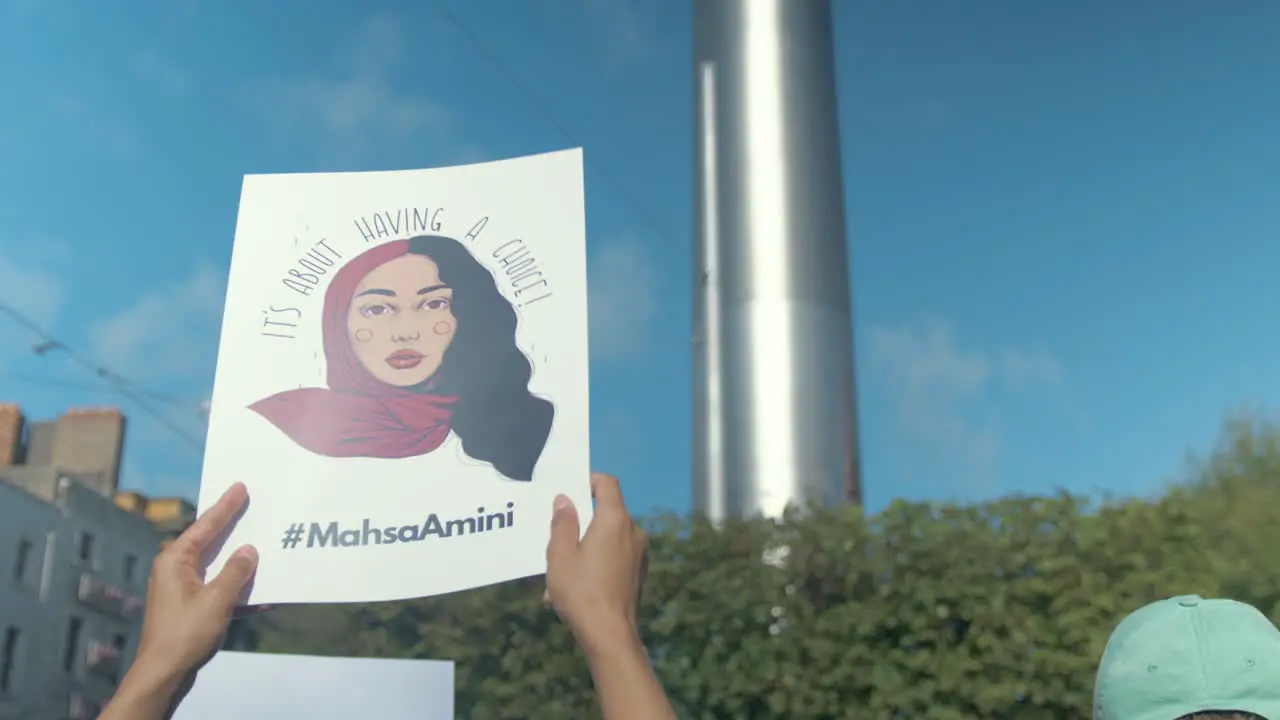 Protest for Mahsa Amini protester holding portrait O'Connell Street Dublin