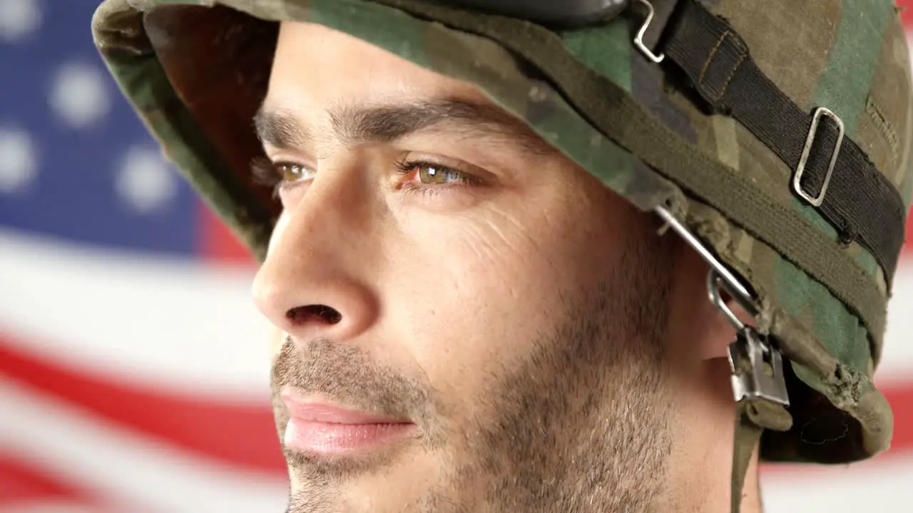 Soldier standing in front of American flag