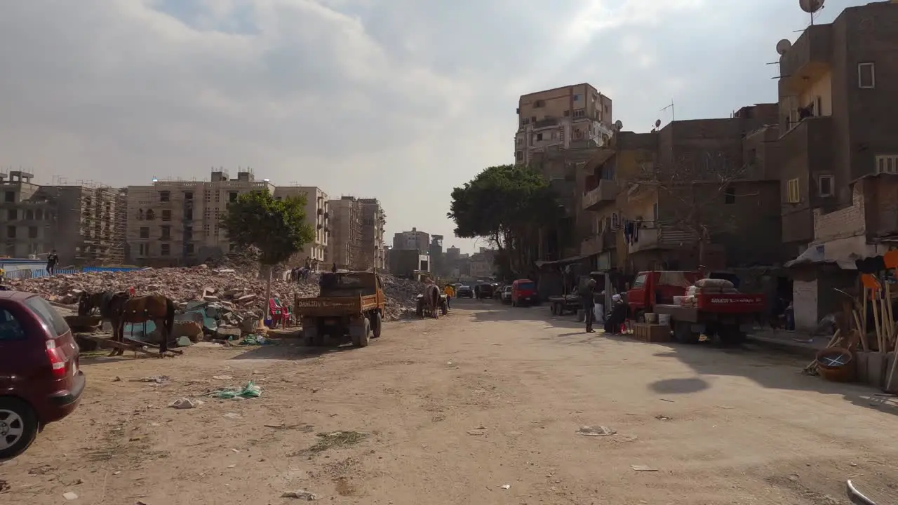 Very poor living conditions in a poor part of the city Cairo traffic on a sandy road