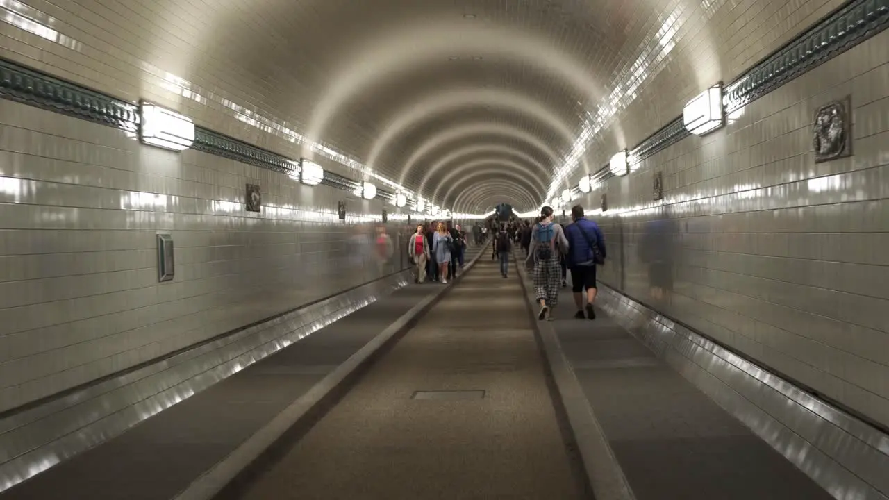 Under the city of Hamburg people walking to catch different subway trains