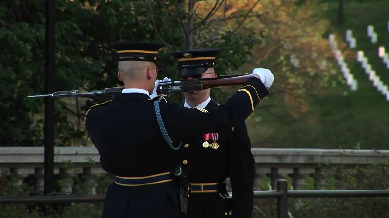 A Soldier Finishes Inspecting Another Soldier'S Gun And Hands It Back To Him