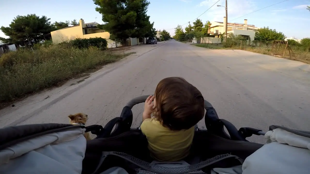 POV footage of a boy in a stroller taking a ride at Kifissia city Greece Wide shot