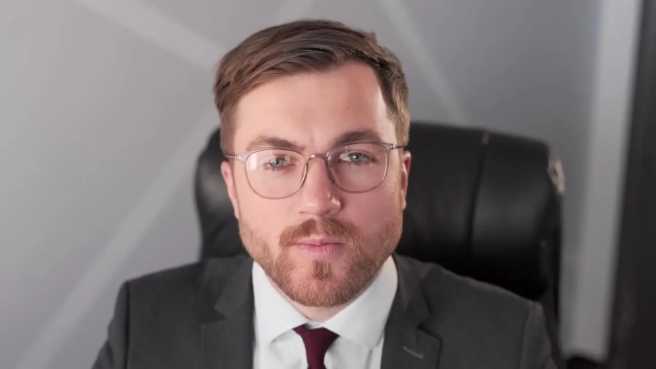 Closeup Bearded Pretty man puts on glasses and starts smiling