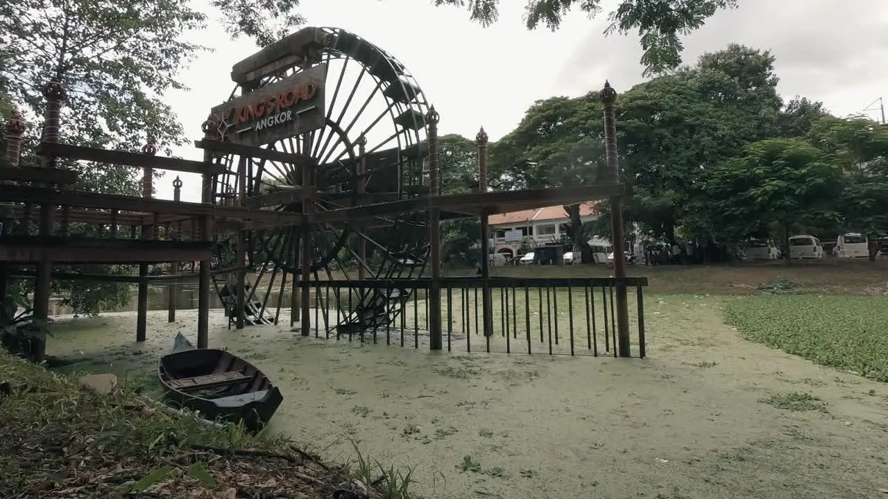 Water Wheel in Algae Filled River