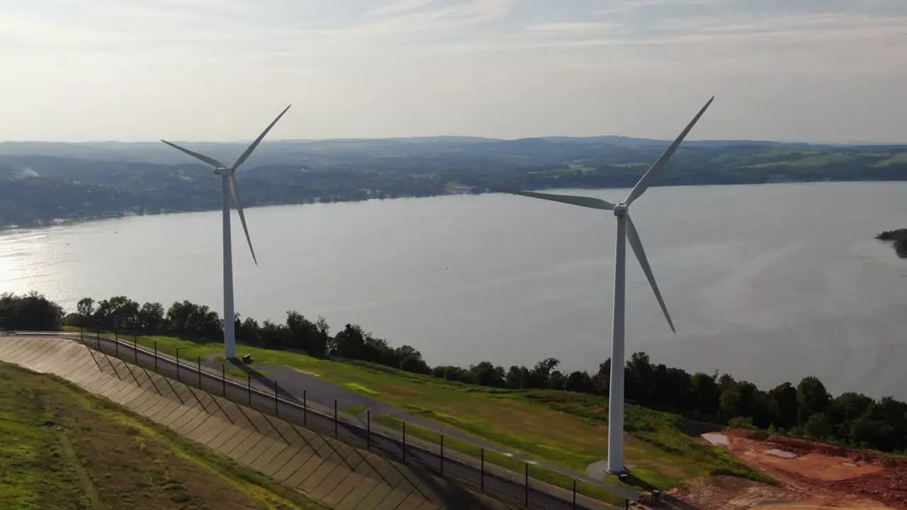 Renewable energy sources hydropower from river and wind energy reducing carbon footprint and reliance on fossil fuels aerial