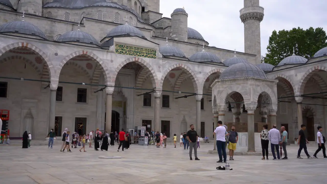 Scene of tourists visiting and taking photos of the iconic Blue Mosque also known as Sultan Ahmed Mosque in Istanbul Turkey