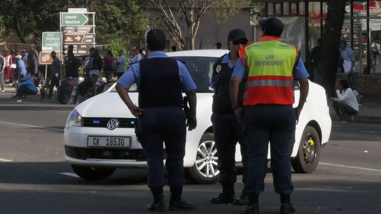 Female South African law enforcement officers block a road during civil unrest