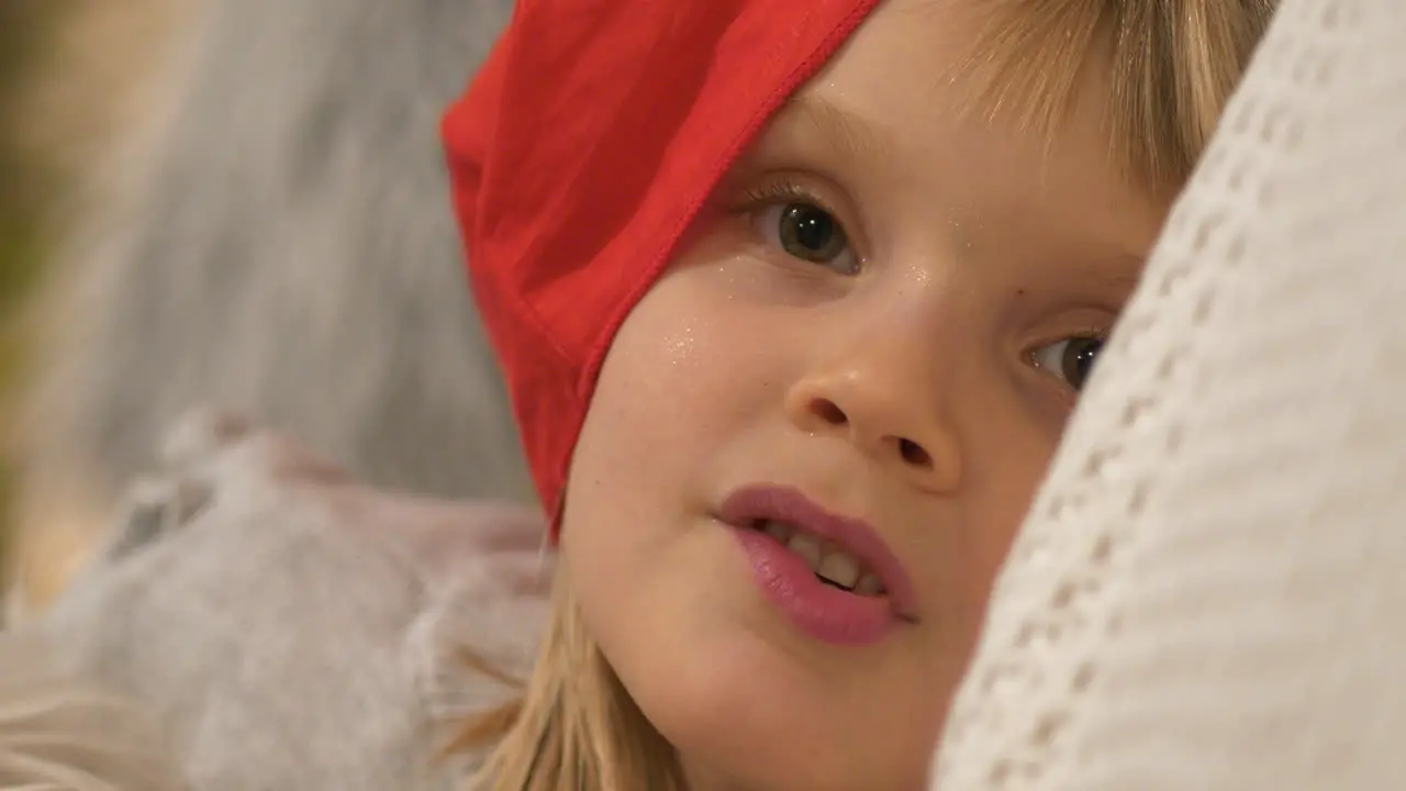 Joyful young little Girl with red hat smiling happily Close up