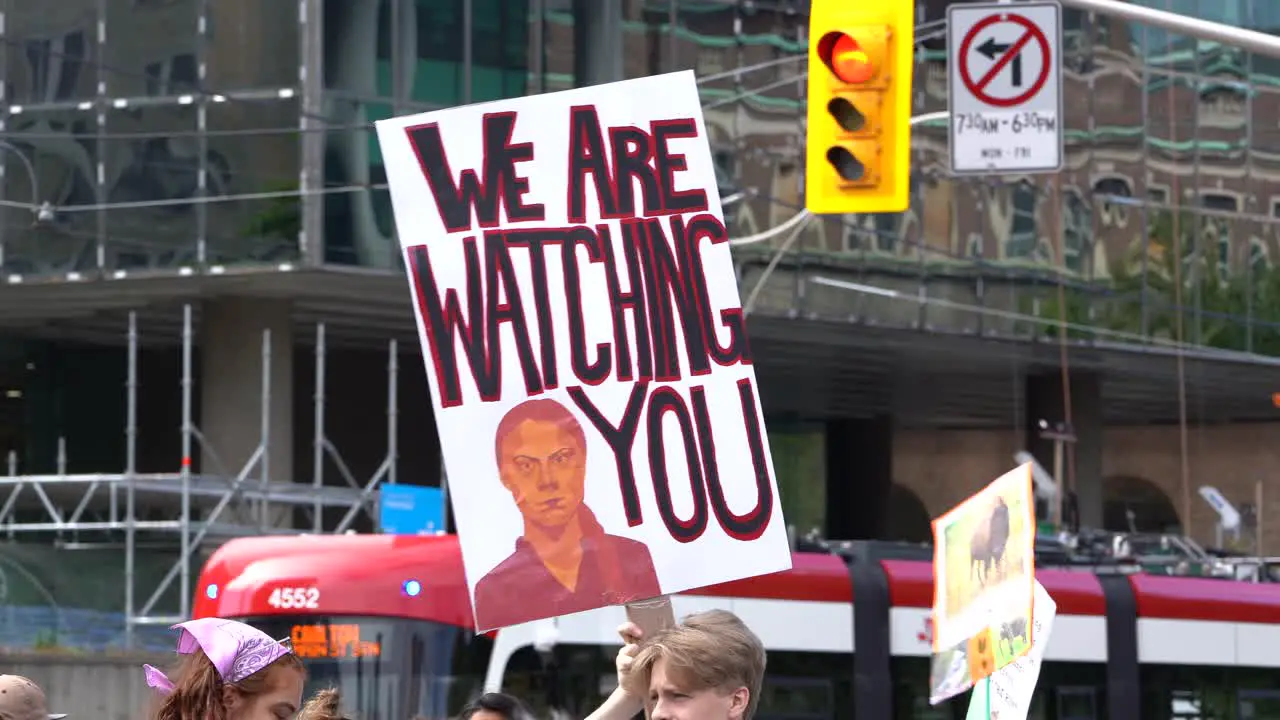 Man holding up Greta Thunberg sign during global climate change March