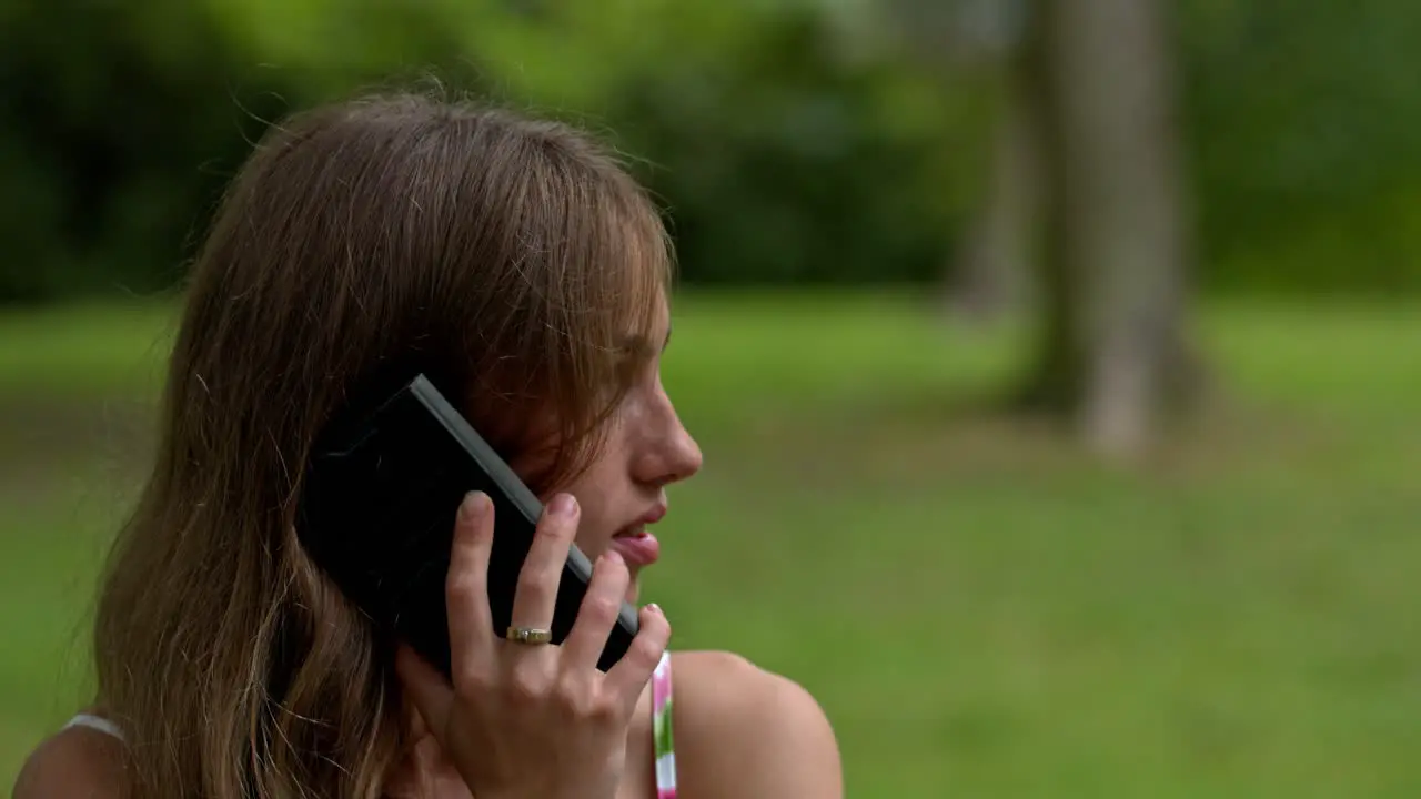 A woman talking on her phone in an outdoor location