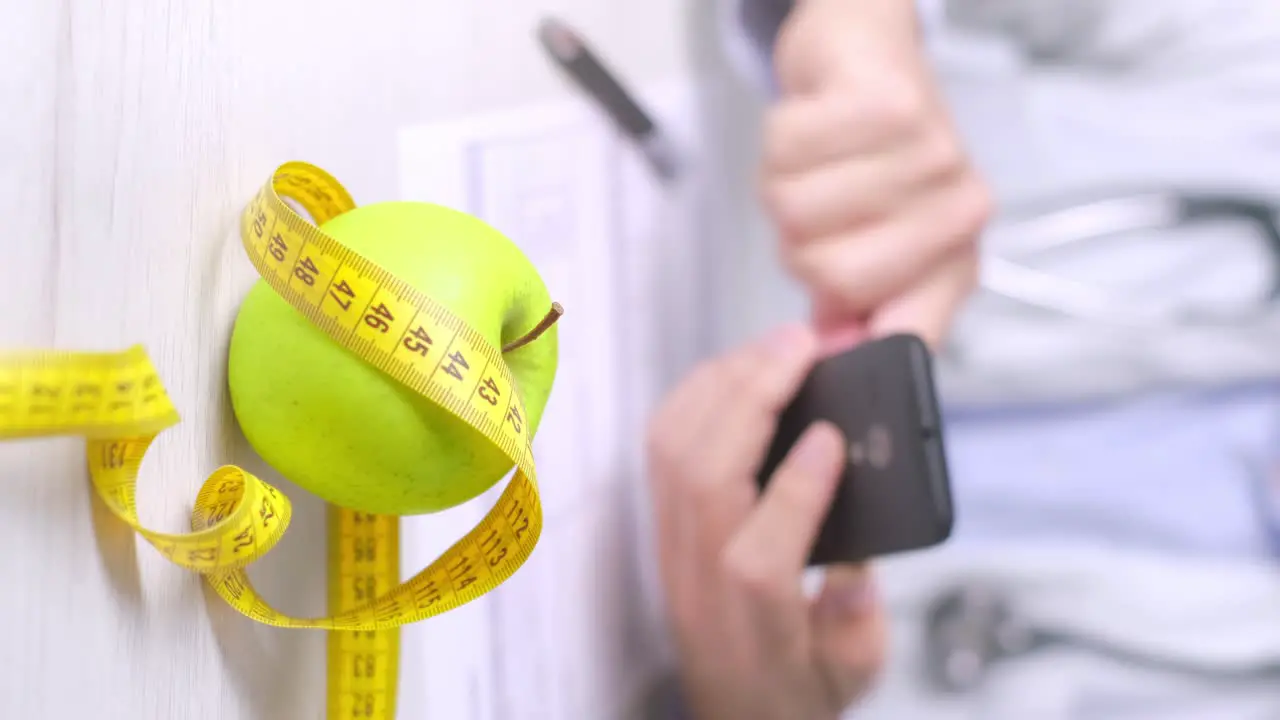 Vertical video of Diet appointment with nutritionist Apple and measuring tape on the table