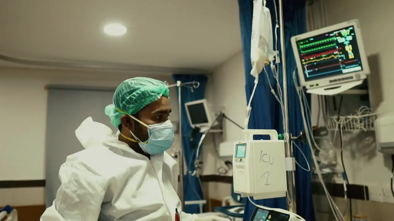 Doctor Checking Intravenous IV Drip In Hospital Ward In Karachi