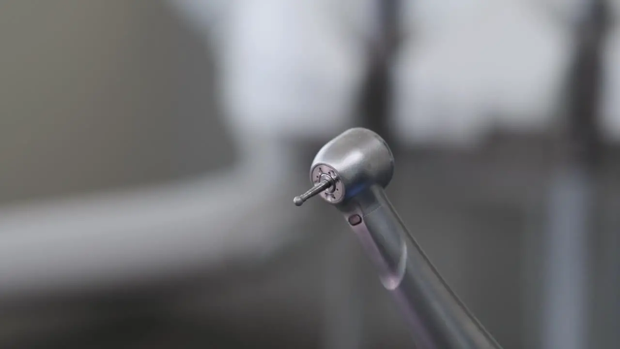 Close-up of a dental drill showing the detail of the head and dental burr