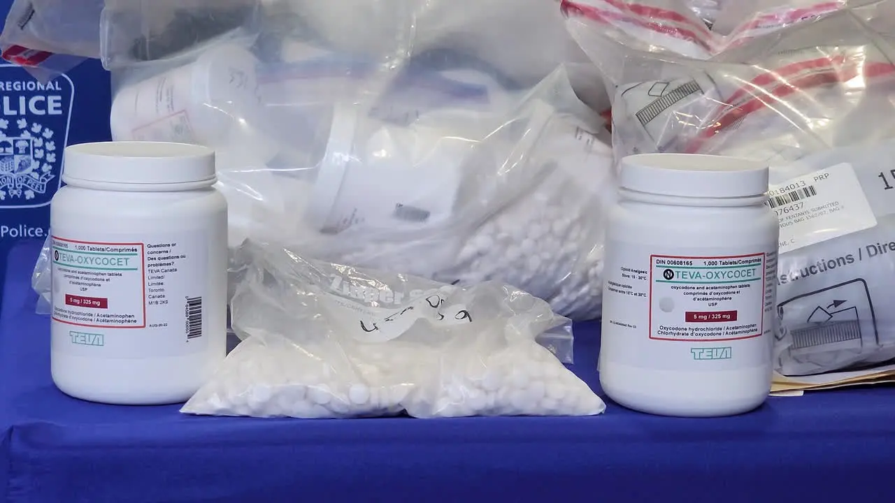 A close up dolly shot of bottles of Teva-Oxycodone and other narcotics seized as evidence during a drug bust by Peel Regional Police after investigating a syndicate operating in Mississauga Canada