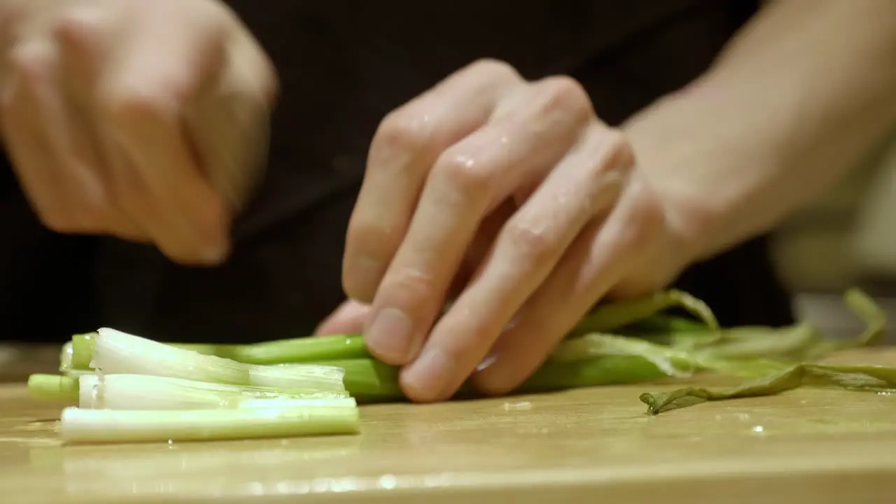 Hands Slicing Scallion By A Sharp Knife