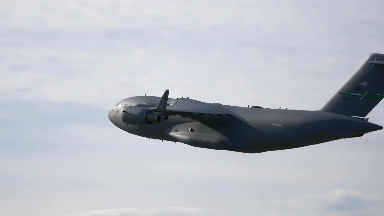 C-17 Military Cargo Plane Flying with Bright Sky Background