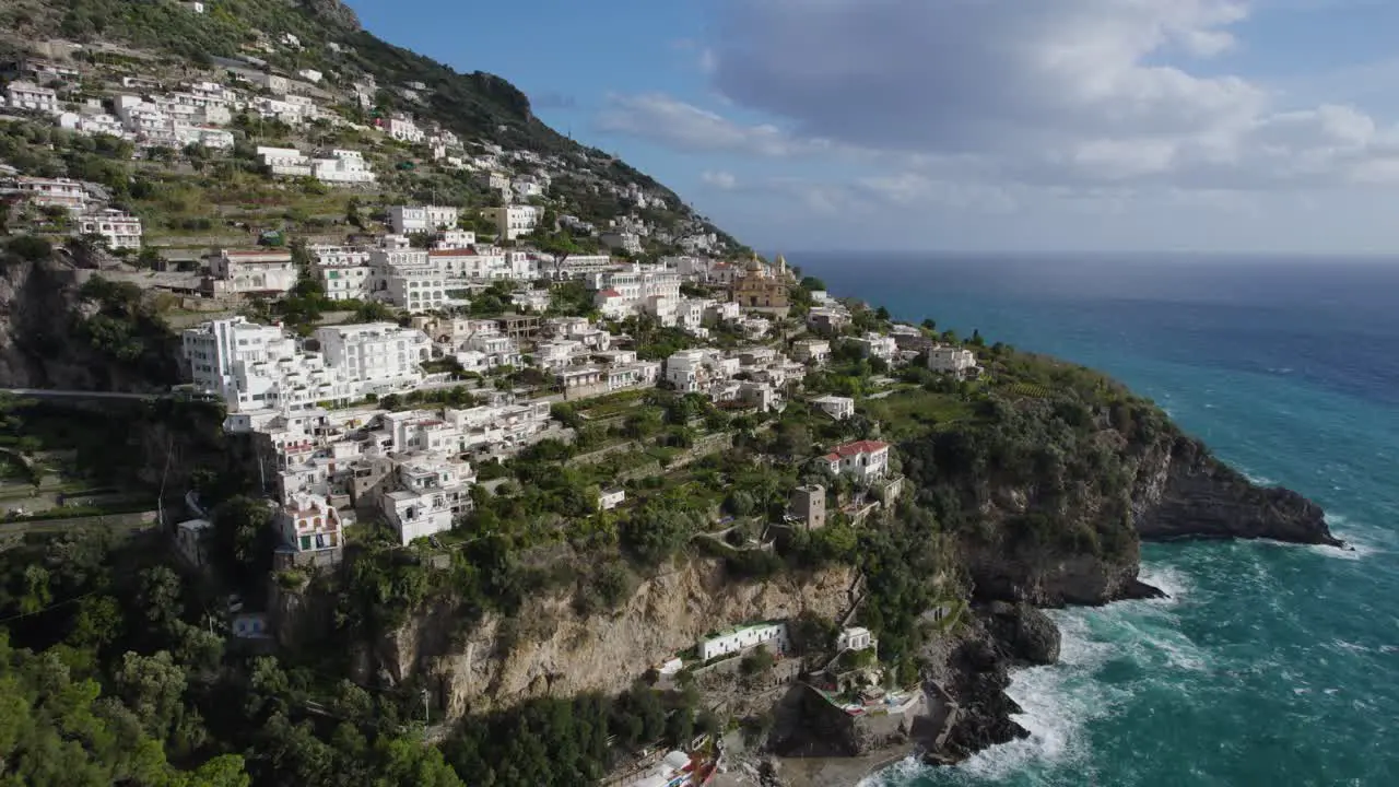 Aerial pullback reveals incredible seaside homes on green cliff amalfi coast italy