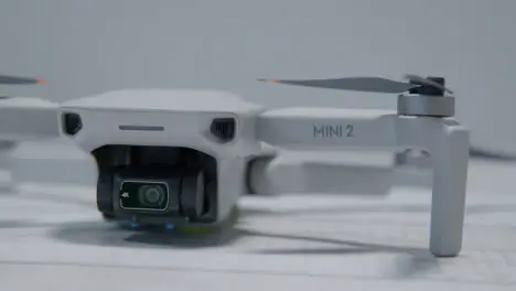 Close Up Shot of DJI Mini 2 Drone Sitting On Table 